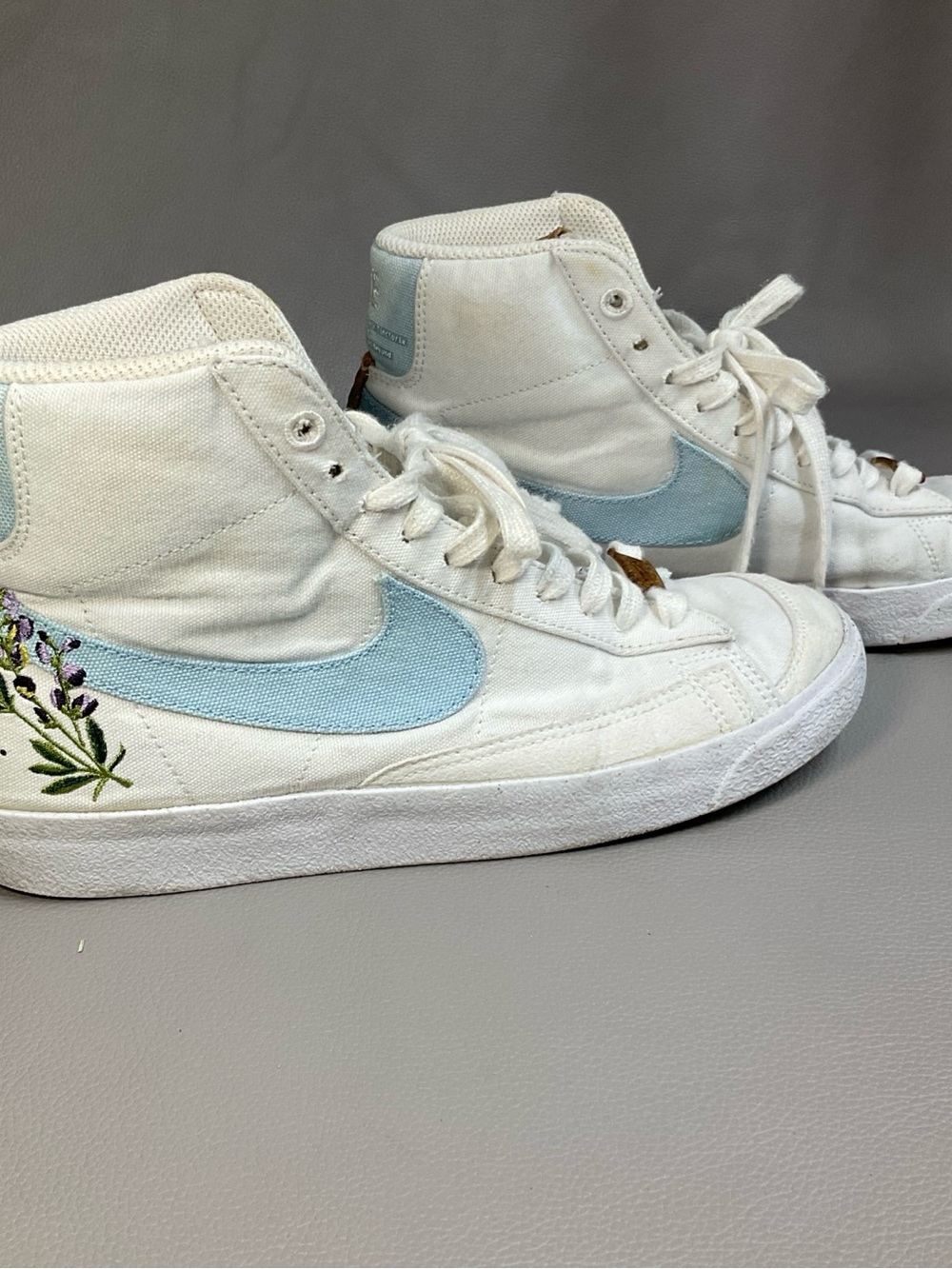 Nike White High-Top Sneakers with Light Blue Swoosh and Floral Embroidery